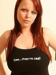 Redheaded busty teen shows off her landing strip