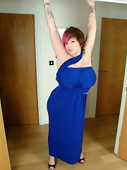 Busty Dors squeezes tits into tight blue dress and plays with pussy